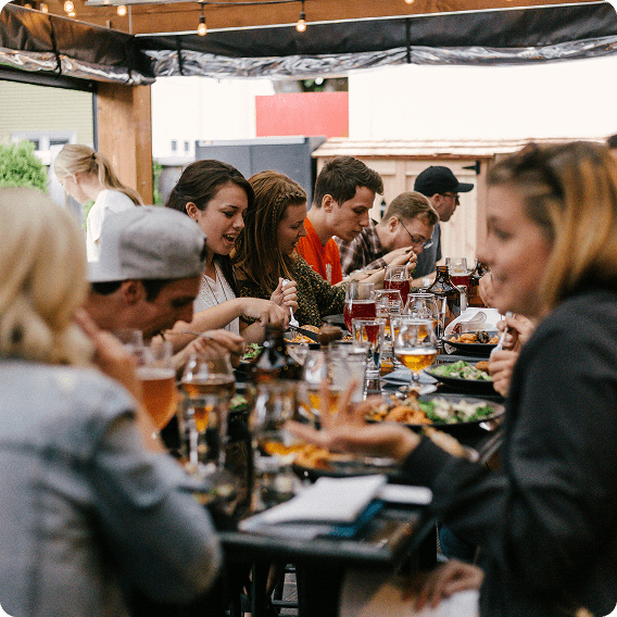 Guests sharing a meal around a restaurant table