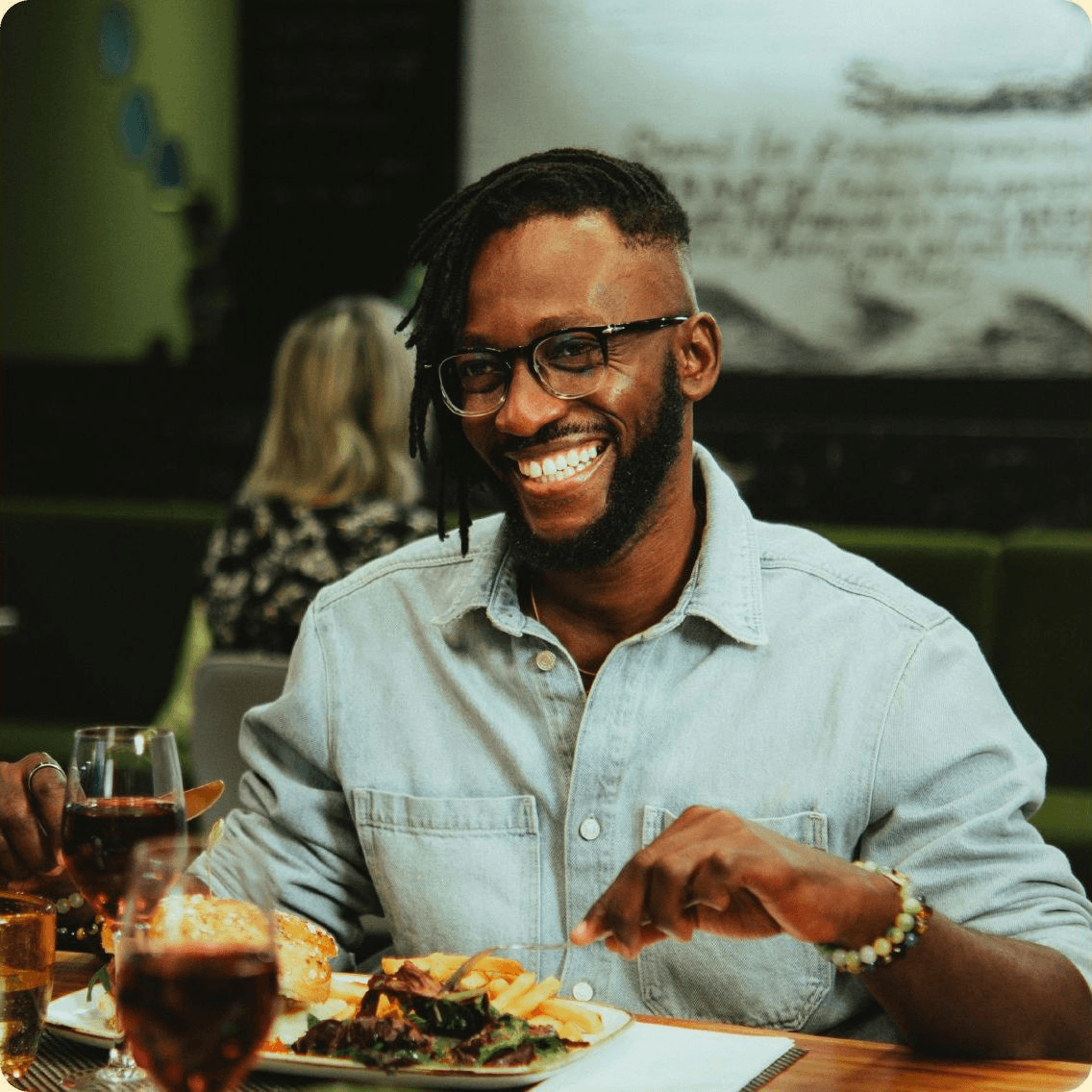 A smiling guest enjoying a meal at a restaurant