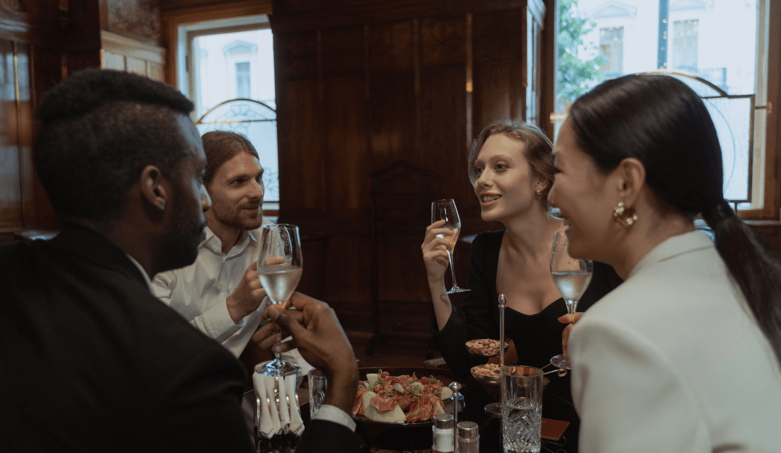 Business guests sharing a meal and conversation.