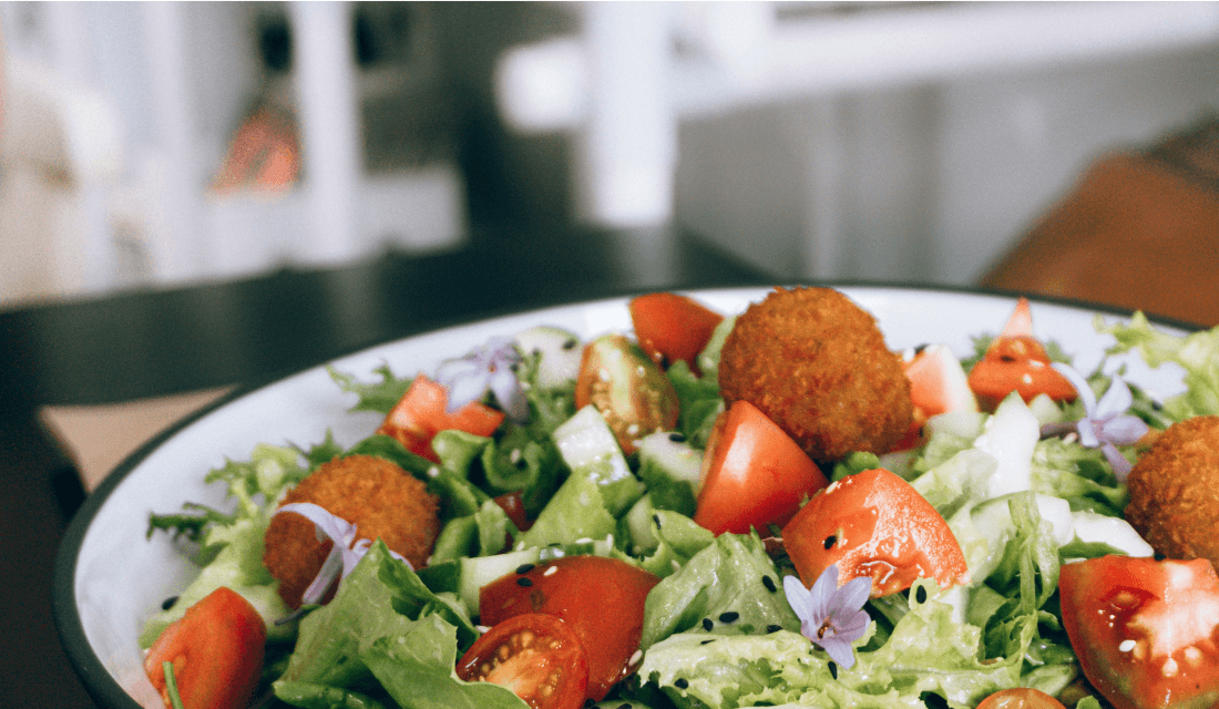 A colourful salad with vegetables and falafel.